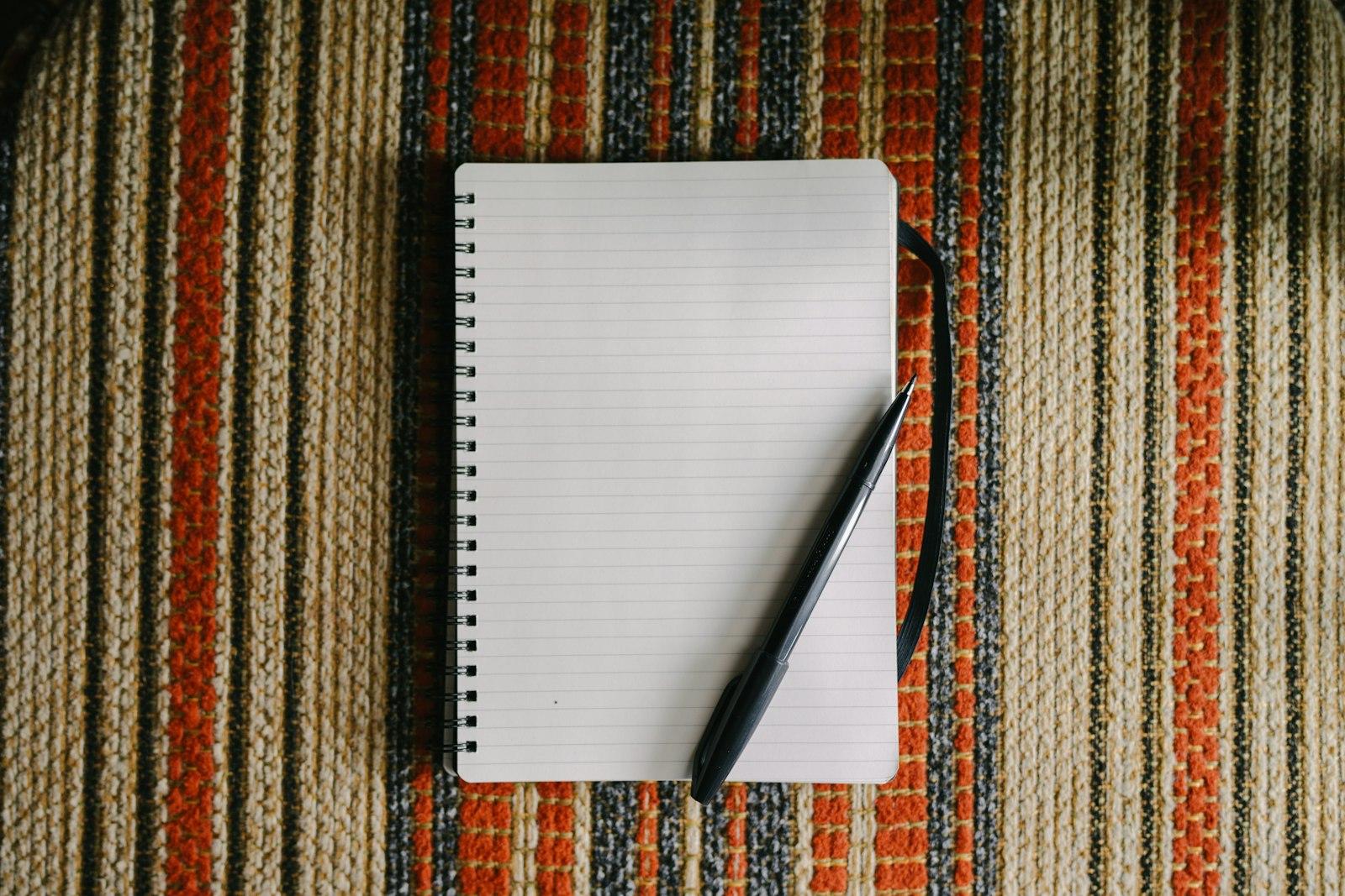 A Blank Notebook With A Pen On Striped Fabric jigsaw puzzle preview