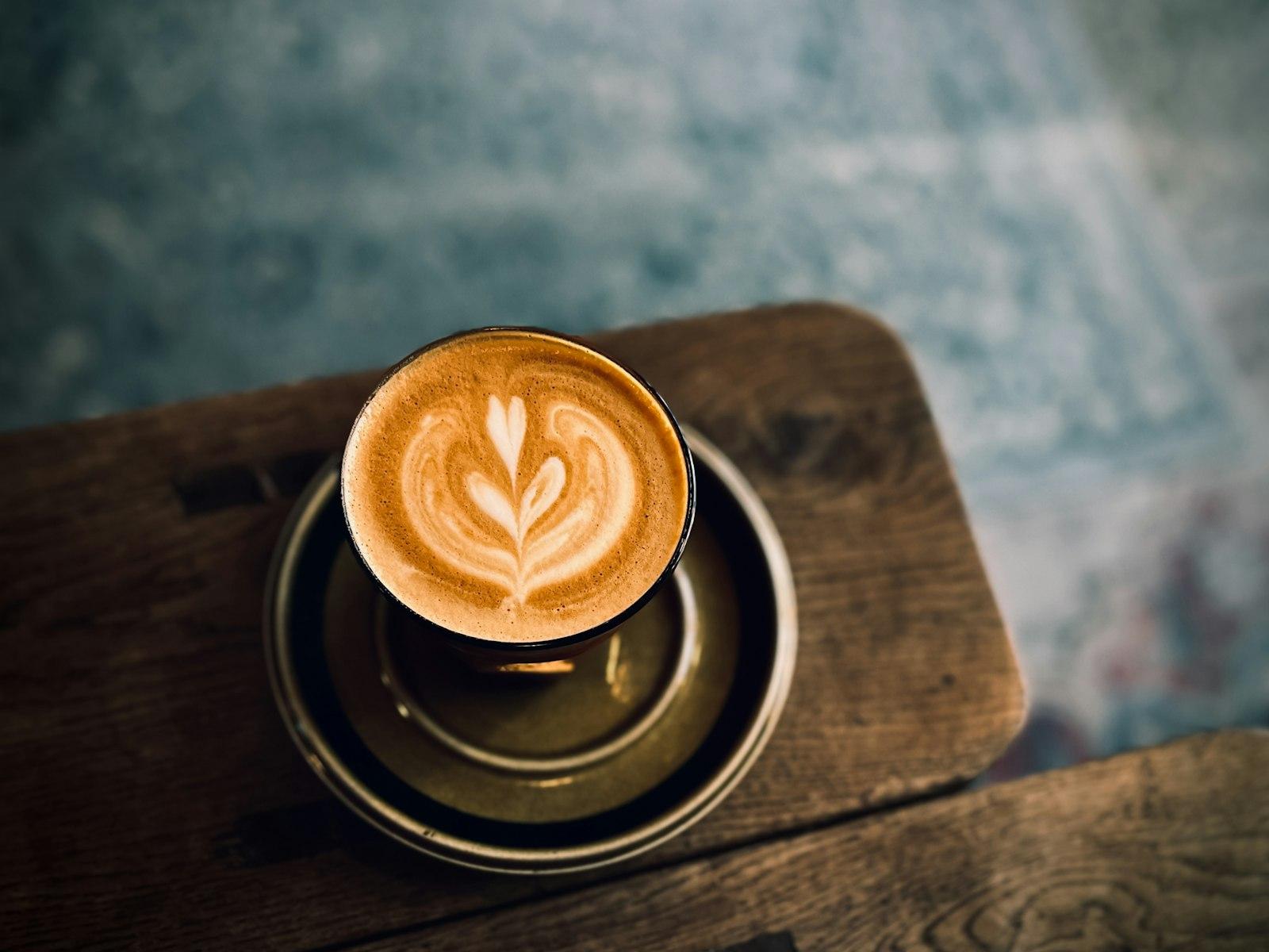 A Cappuccino Sitting On Top Of A Wooden Table jigsaw puzzle preview