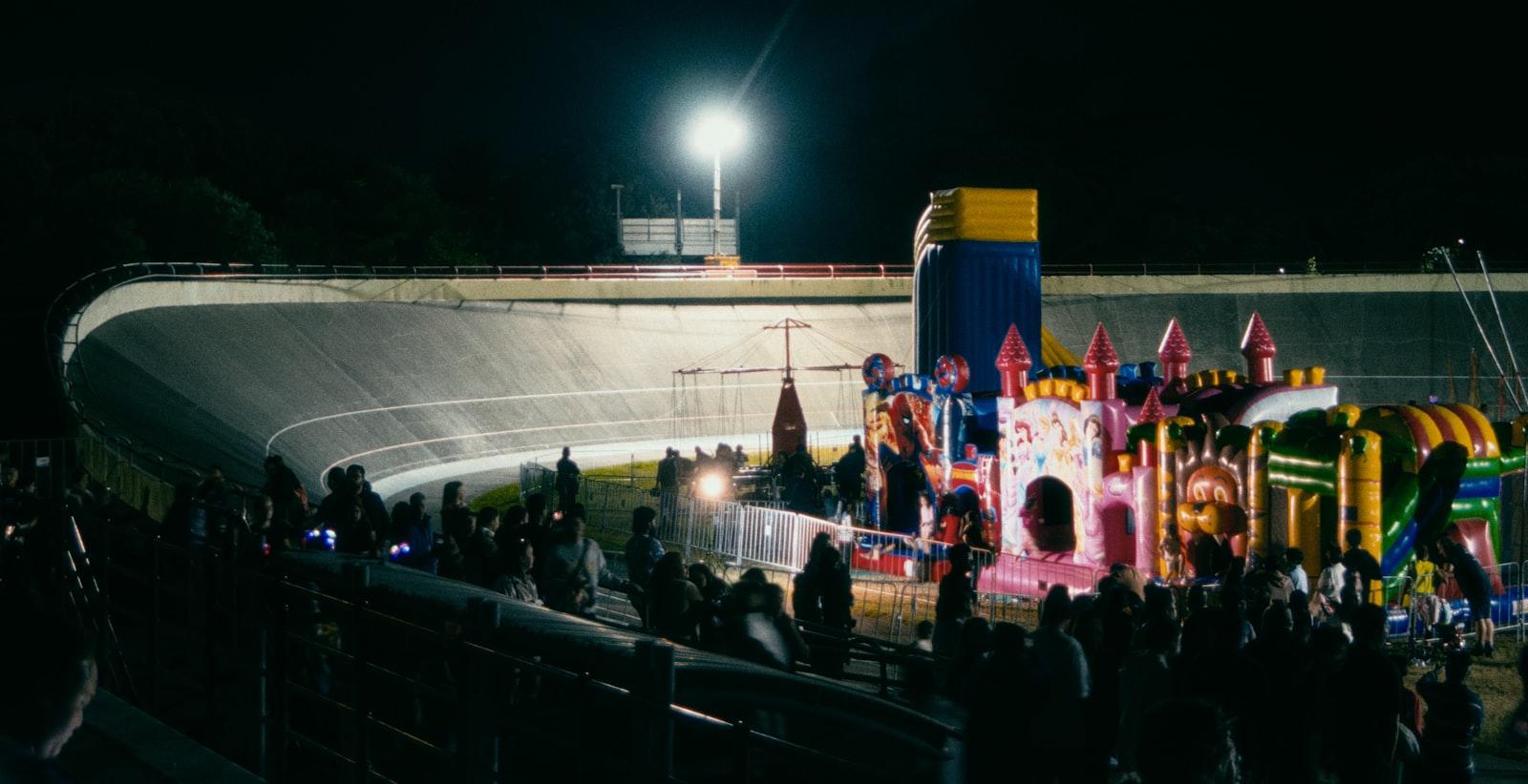A Crowd Of People Standing Around A Carnival Ride jigsaw puzzle preview