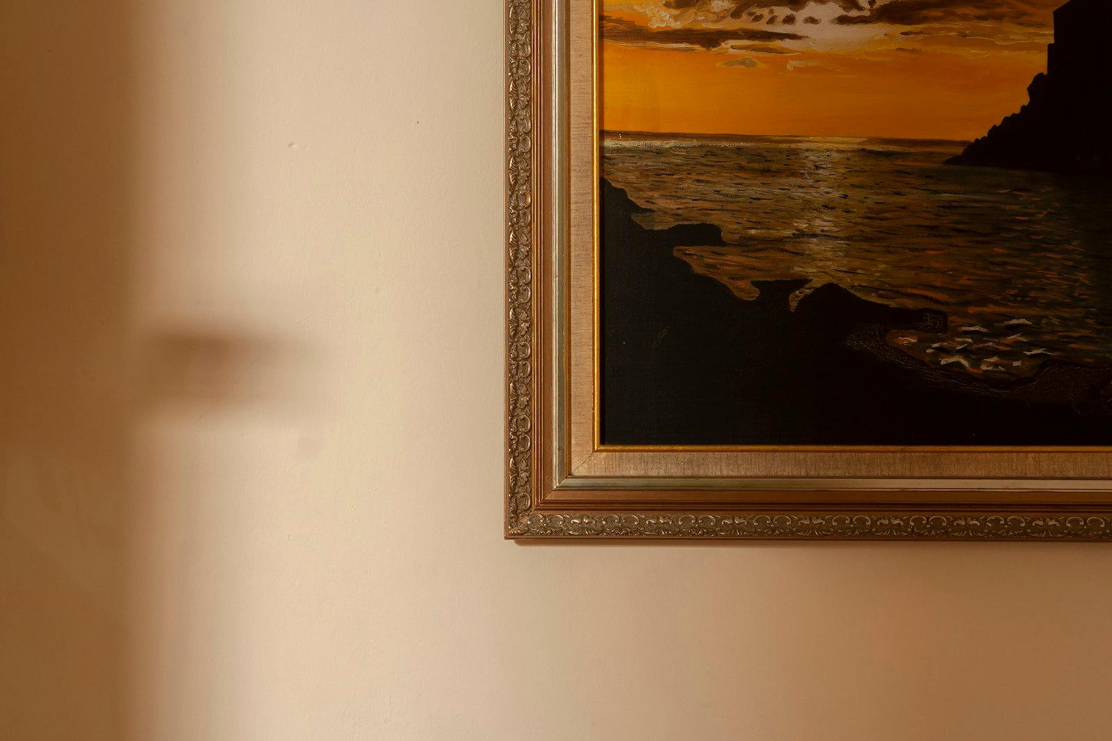 A Framed Landscape Painting Hangs On A Wall jigsaw puzzle preview