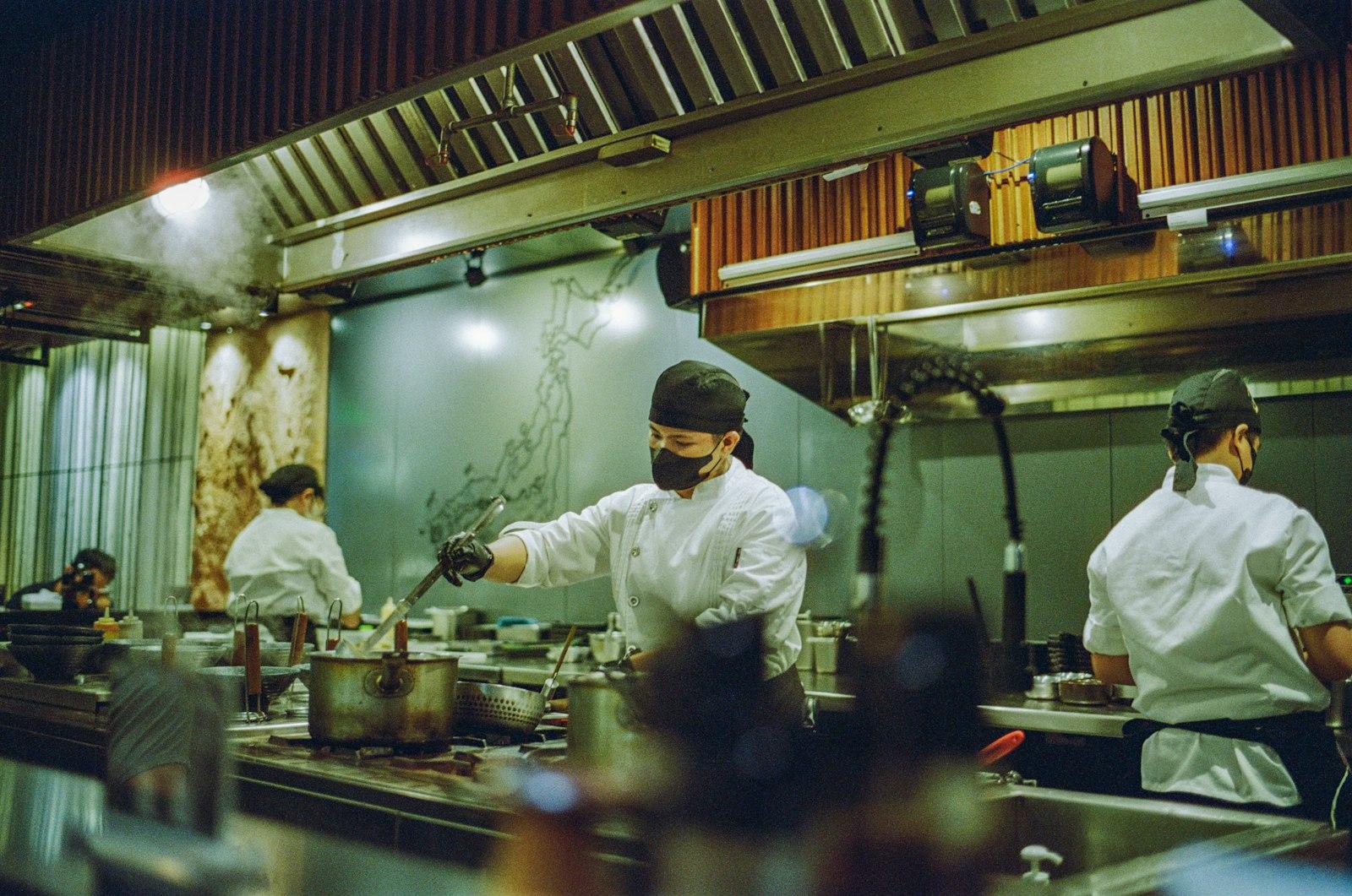 A Group Of Chefs Preparing Food In A Kitchen jigsaw puzzle preview