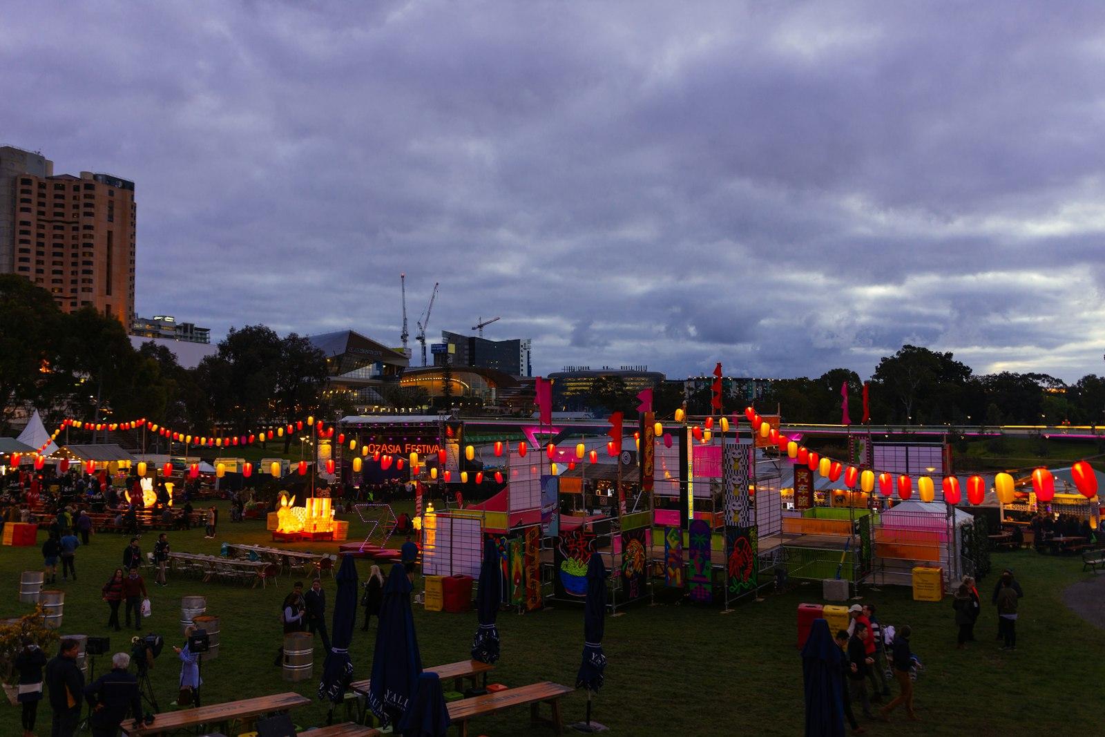 A Group Of People Standing Around A Carnival Tent jigsaw puzzle preview