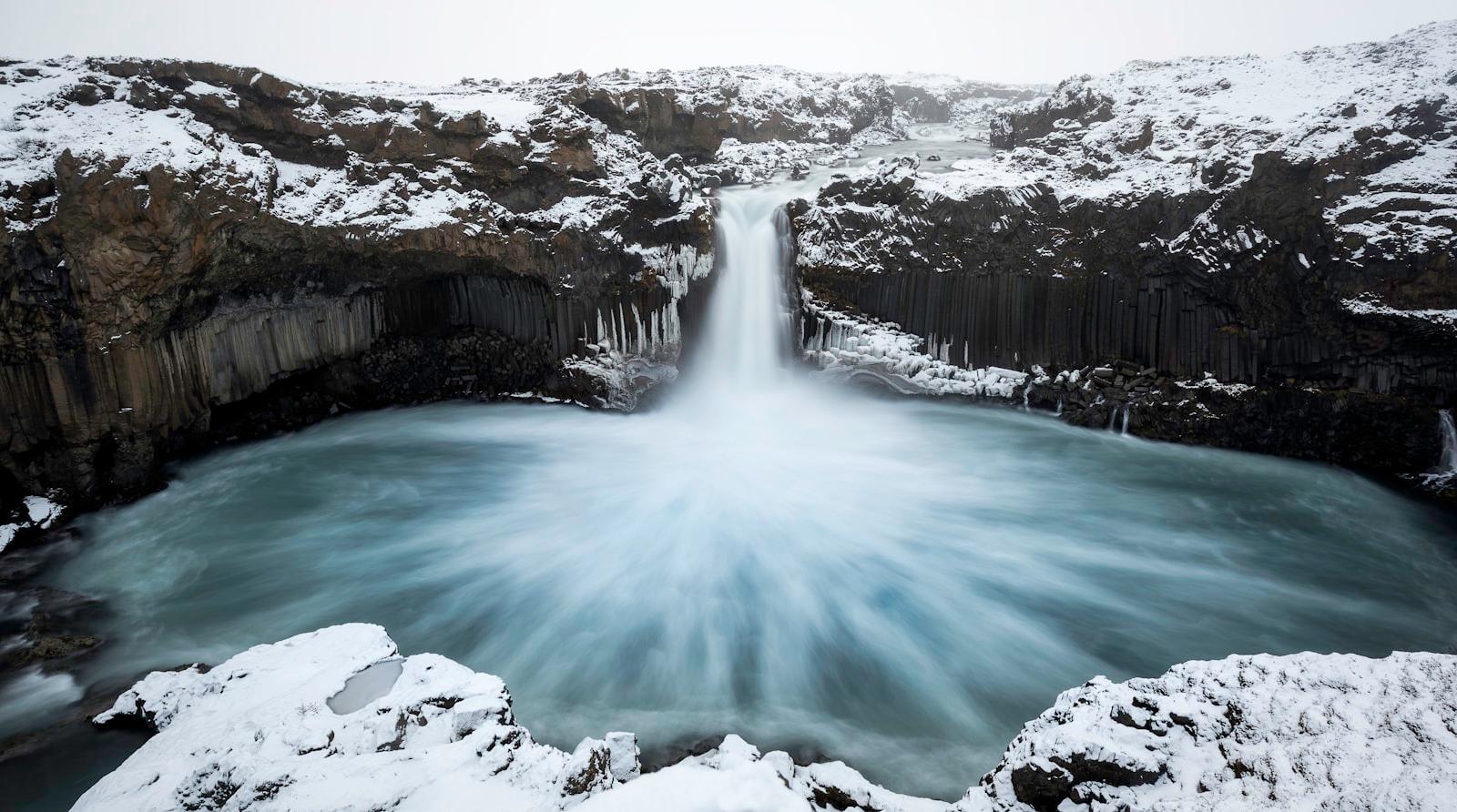 A Large Waterfall Is Surrounded By Snow jigsaw puzzle preview
