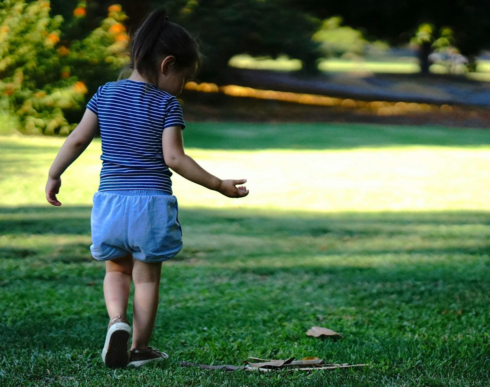 A Little Girl Standing On Top Of A Lush Green Fiel jigsaw puzzle preview