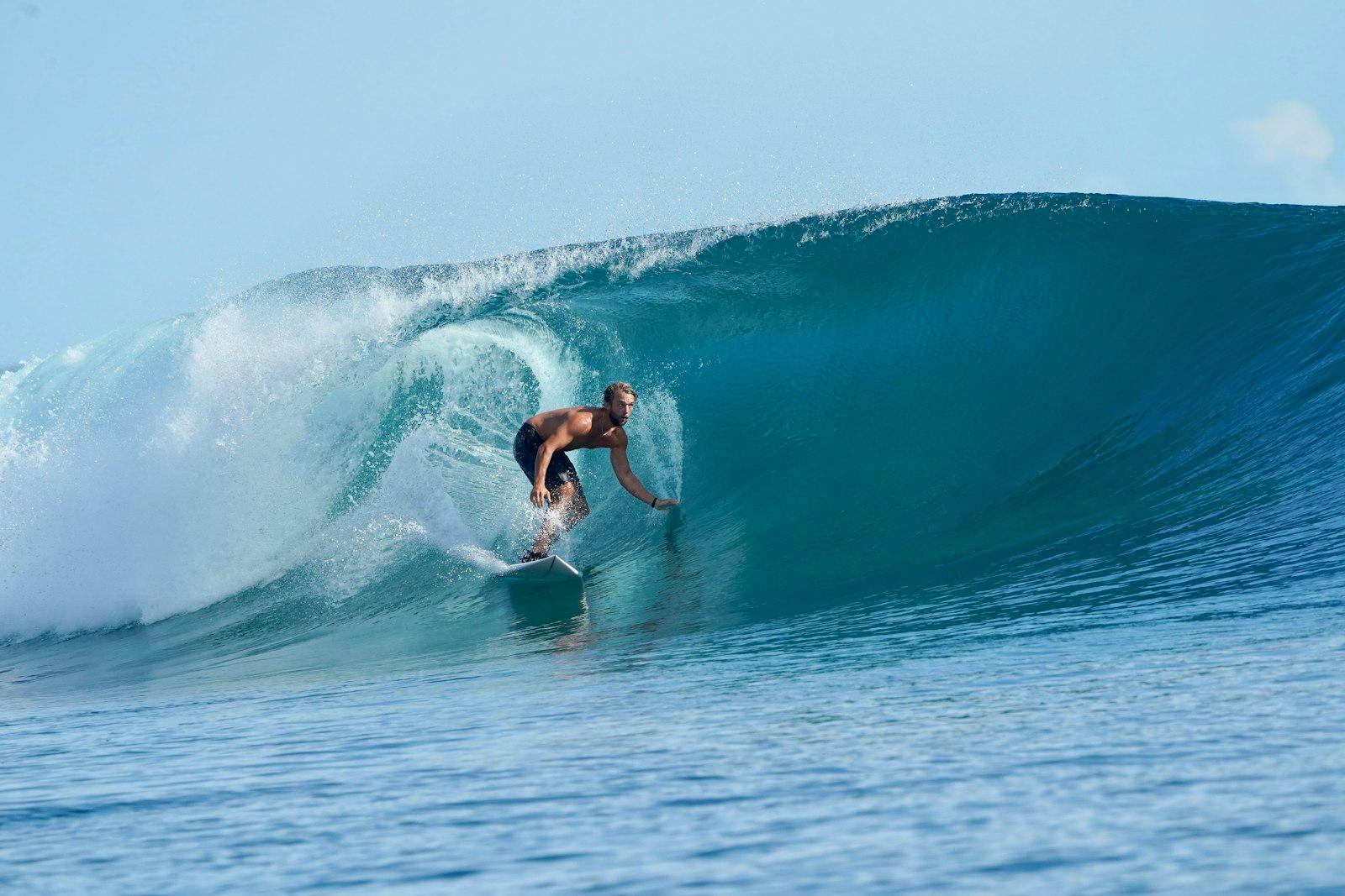 A Man Riding A Wave On Top Of A Surfboard jigsaw puzzle preview