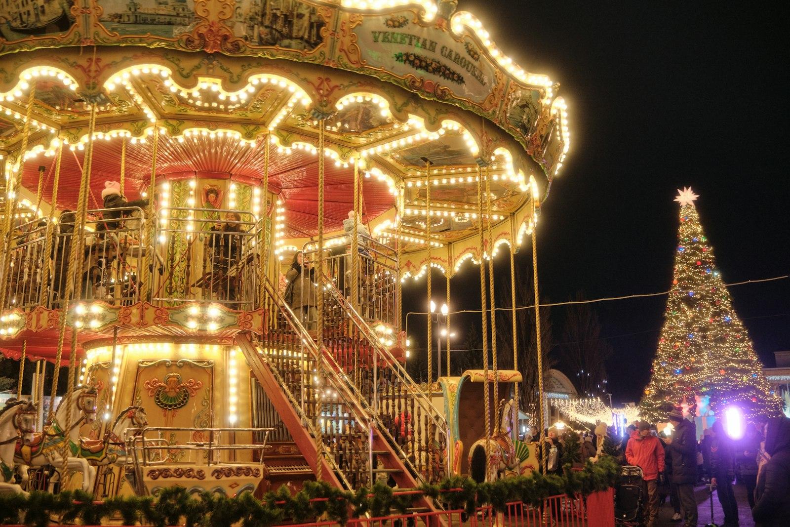 A Merry Go Round At Night With A Christmas Tree In jigsaw puzzle preview
