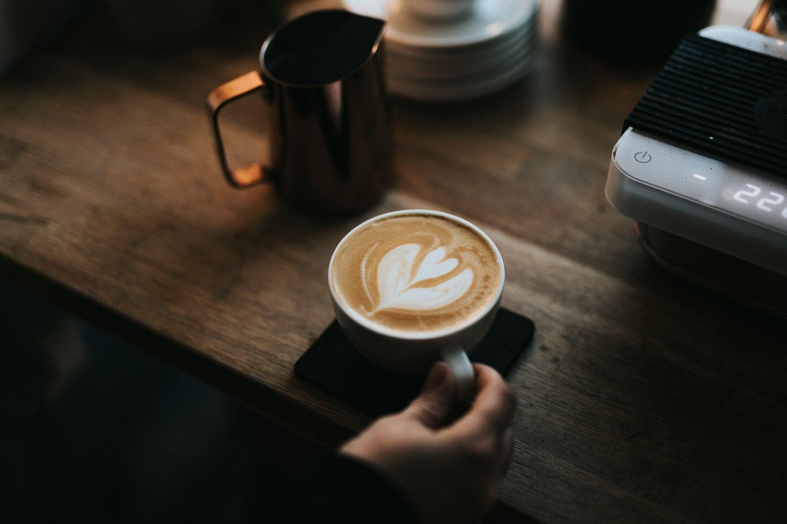 A Person Holding A Cup Of Coffee On Top jigsaw puzzle preview