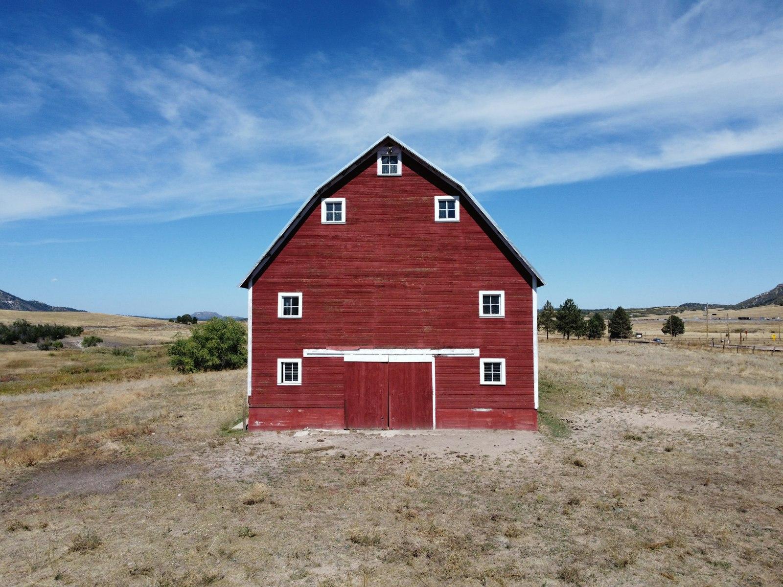 A Red Barn With A White Door And Windows jigsaw puzzle preview