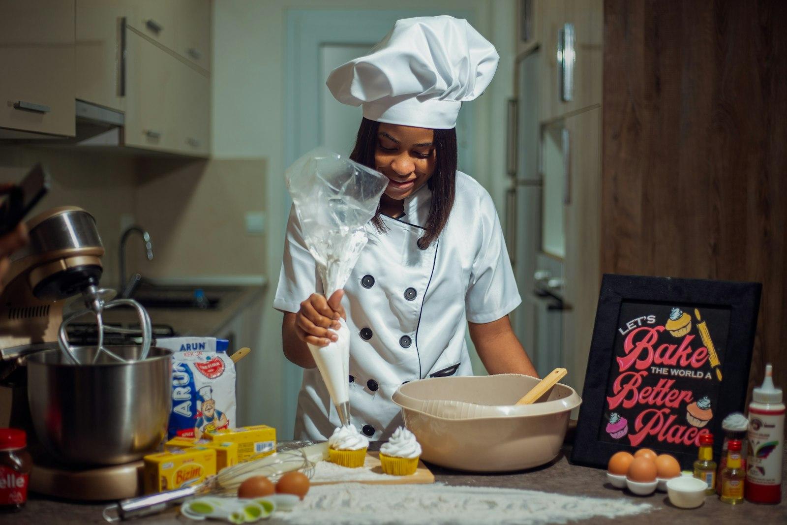A Woman In A Chef'S Outfit Preparing Food In A Kit jigsaw puzzle preview