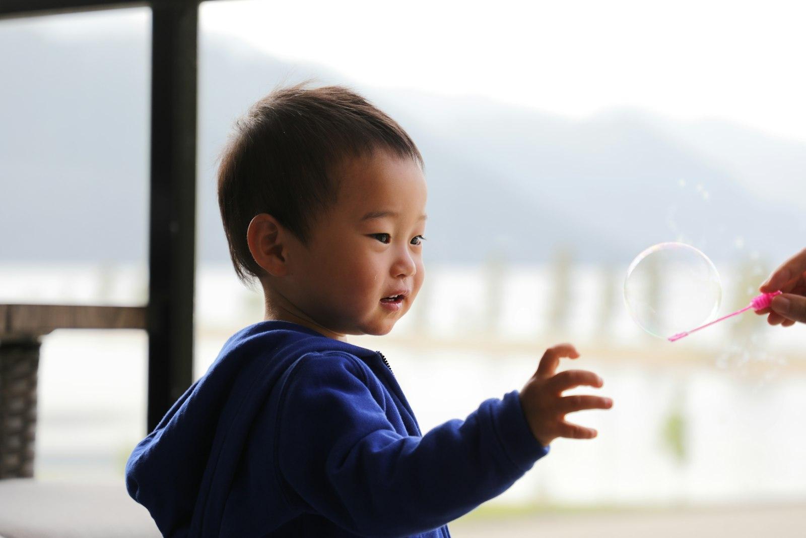 A Young Child Reaches For A Floating Bubble Outdoo jigsaw puzzle preview