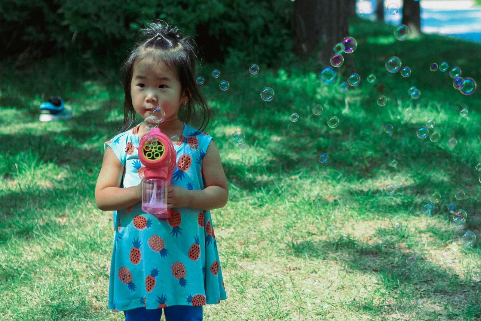 A Young Girl Blows Bubbles With A Bubble Gun Outdo jigsaw puzzle preview