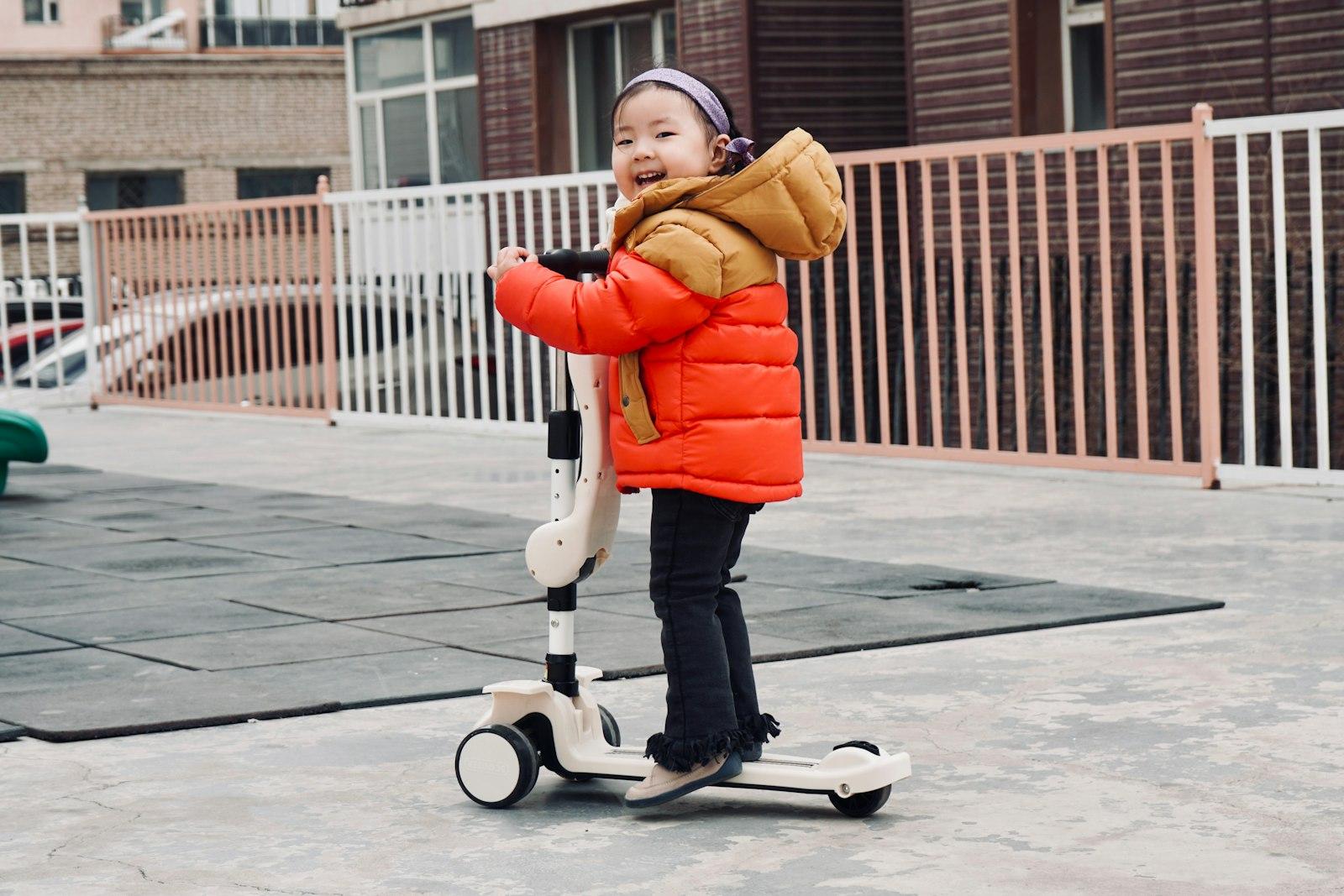 A Young Girl Rides A Scooter Outdoors jigsaw puzzle preview