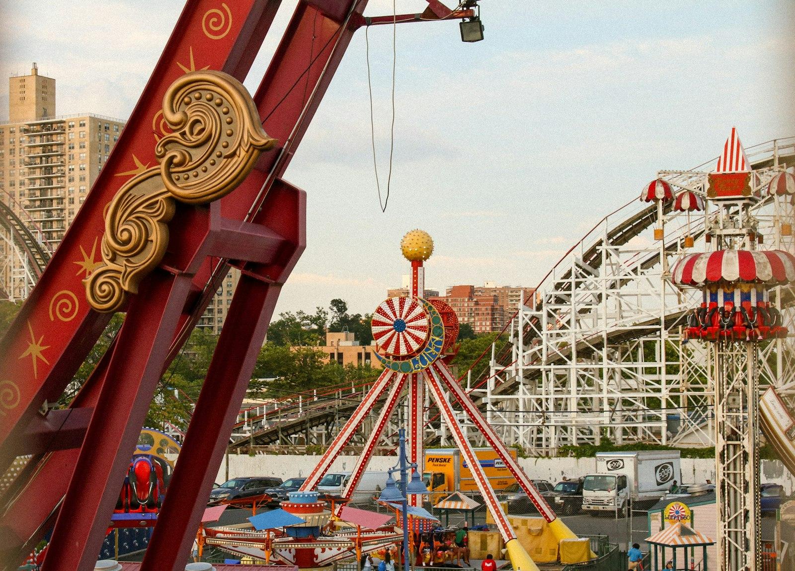Amusement Park Rides With Roller Coaster In Backgr jigsaw puzzle preview