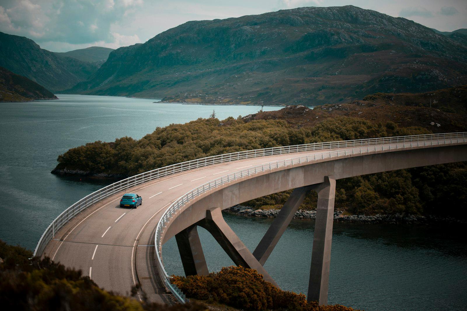 Blue Vehicle Driving On Bridge During Daytime jigsaw puzzle preview