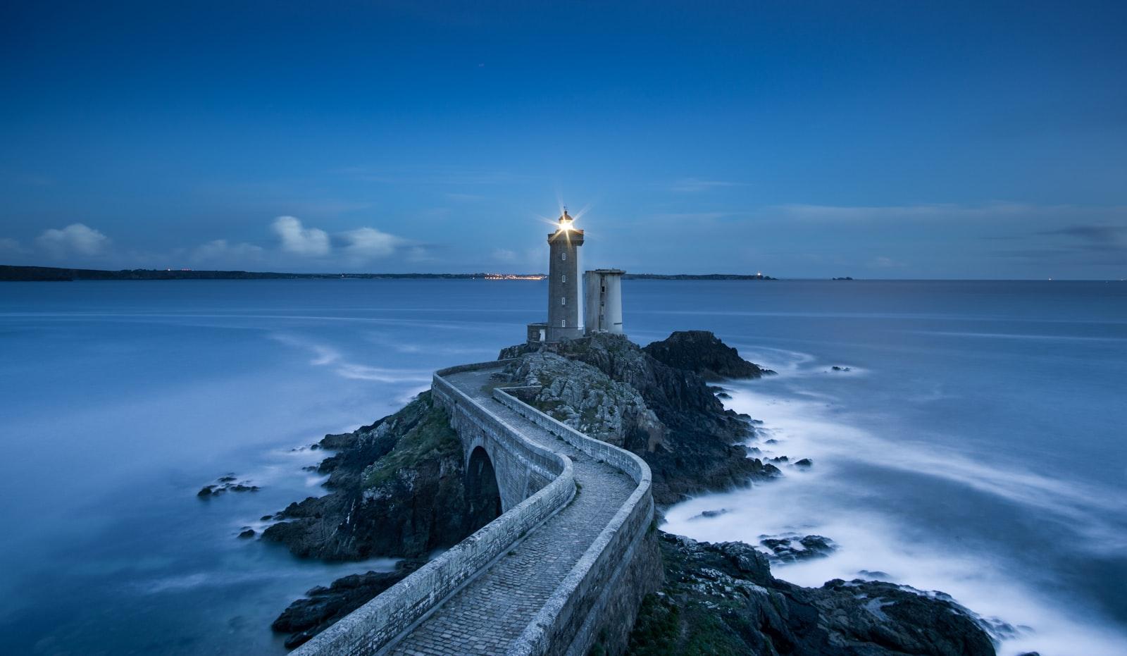 Gray Lighthouse On Islet With Concrete Pathway At jigsaw puzzle preview