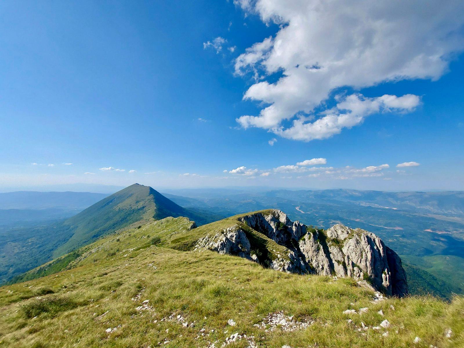 Green Grass Field And Mountain Under Blue jigsaw puzzle preview
