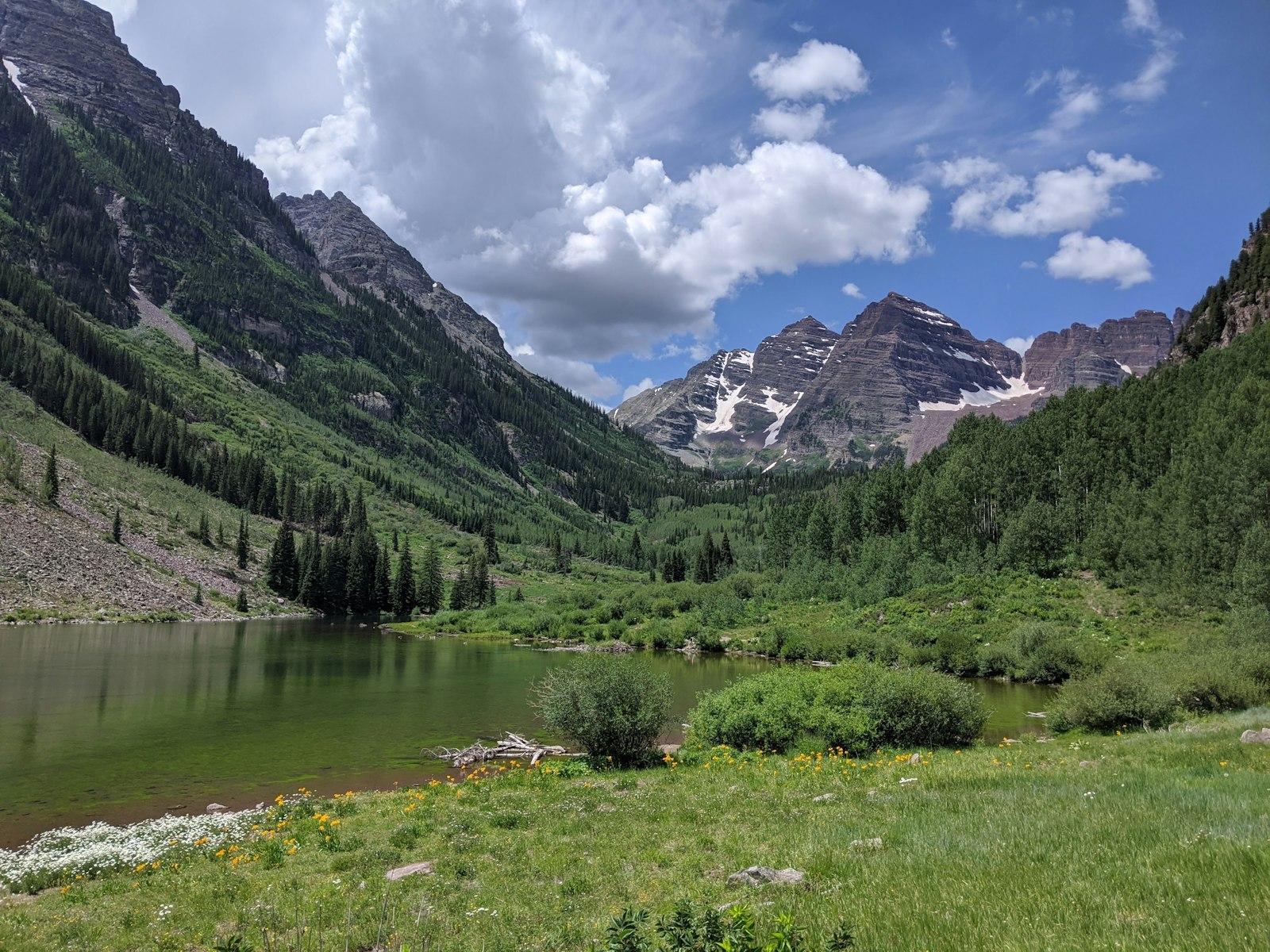 Green Grass Field Near Lake And Mountains jigsaw puzzle preview
