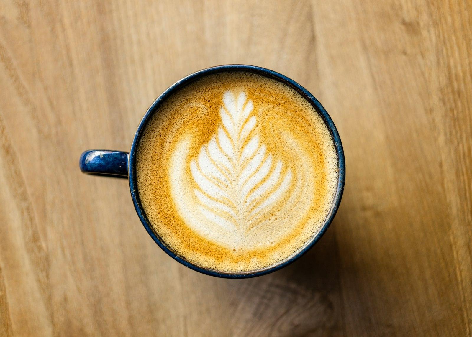 Latte Art In A Blue Mug Sitting On A Wooden jigsaw puzzle preview