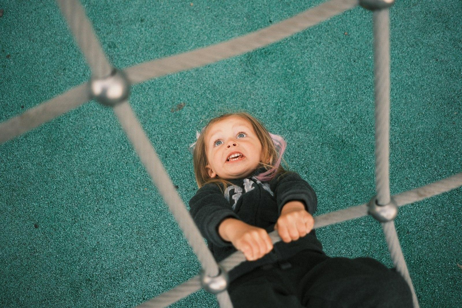 Little Girl Climbing A Rope Net, Looking Up Intent jigsaw puzzle preview