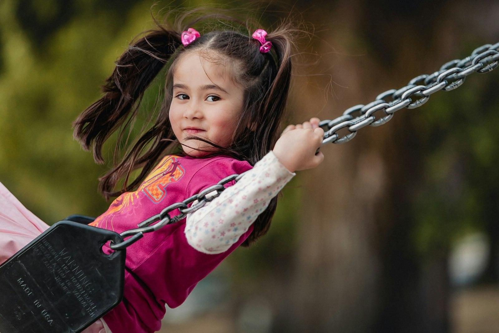 Little Girl With Pigtails Enjoys Swinging Outdoors jigsaw puzzle preview