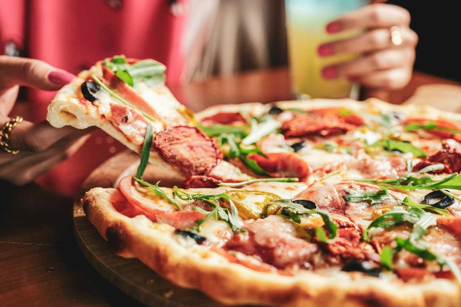 Pizza With Green Leaf On Brown Wooden Table jigsaw puzzle preview