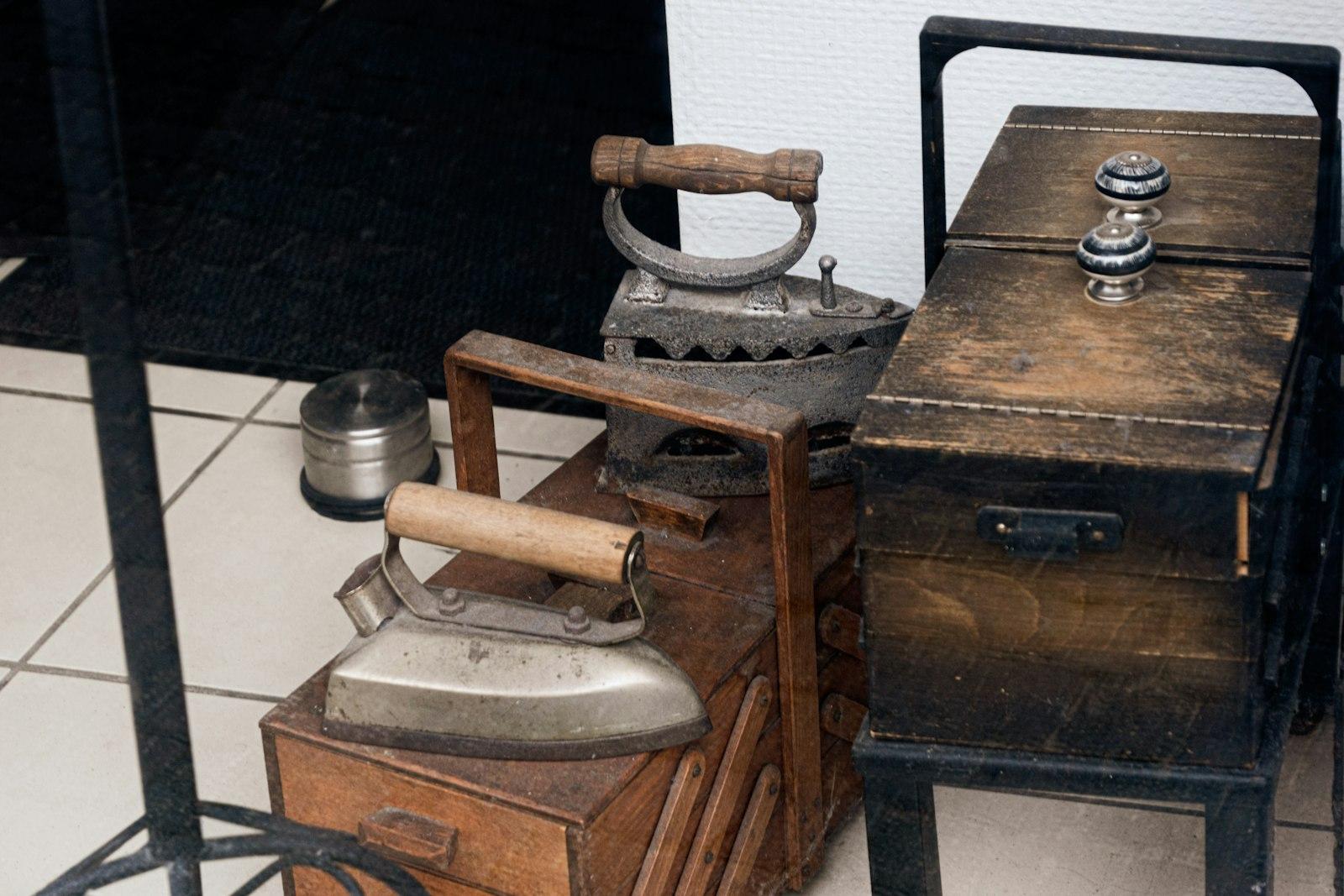 Three Antique Irons Resting On Wooden Boxes jigsaw puzzle preview