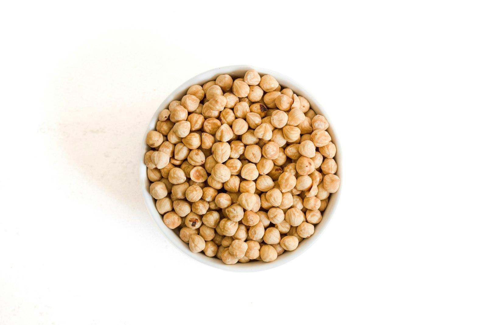 Top View Of Roasted Hazelnuts In A White Bowl On M jigsaw puzzle preview