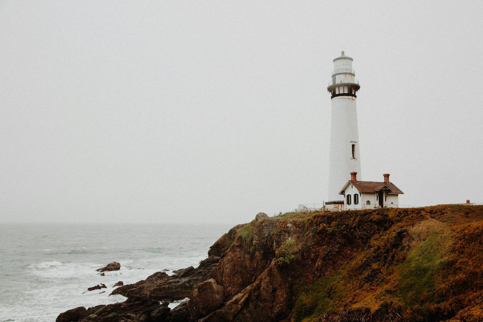White Lighthouse On Rocky Cliff jigsaw puzzle preview