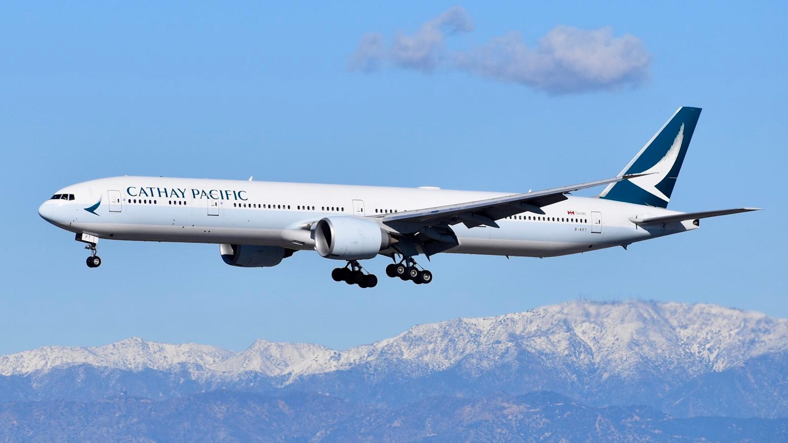 White Passenger Plane Flying Over Snow Covered Mou jigsaw puzzle preview