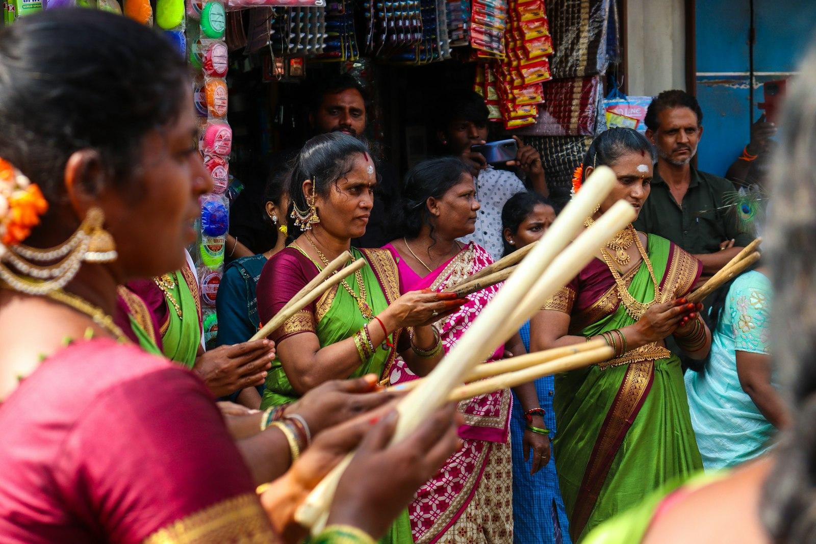 Women In Colorful Saris Holding Wooden Sticks jigsaw puzzle preview