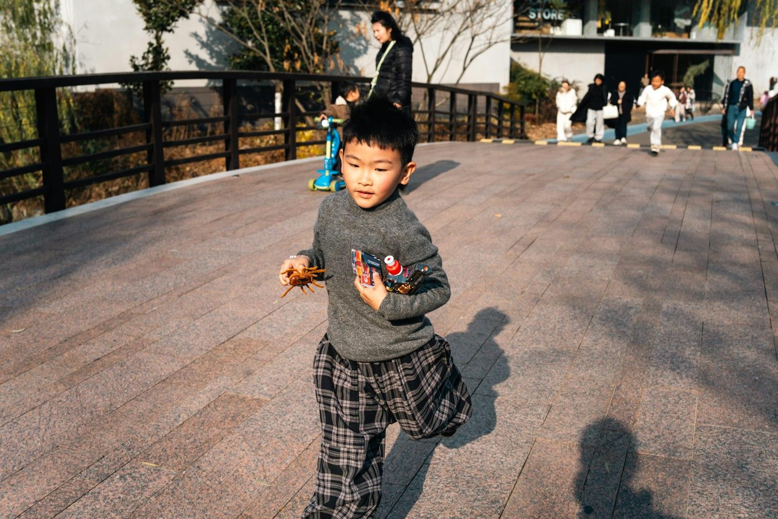 Young Boy Running Across A Bridge With People In B jigsaw puzzle preview